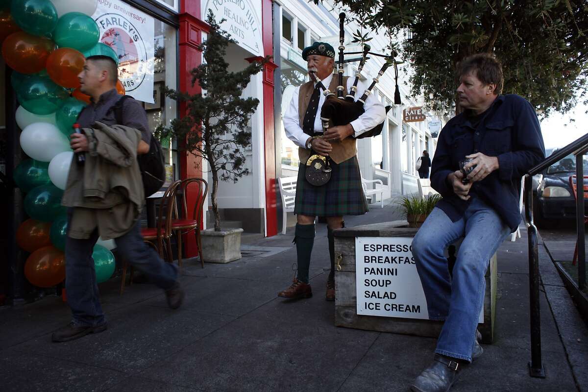 Lynne Miller plays the bagpipes outside of Farley's Coffee in Potrero Hill where people gathered to celebrate its 25th anniversary on St. Patrick's Day, Monday March 17, 2014, in San Francisco, Calif.