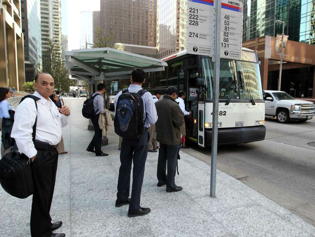 People line-up for the park and ride Grand Parkway METRO Bus 222 as it stops at Louisiana and Mckinney in downtown Houston Thursday March 20, 2014.