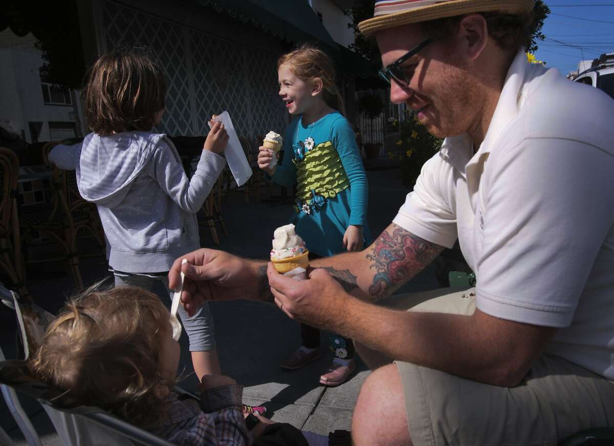 Dagan Ministero,right, Lillian Ministero,middle, and Sunny Ministero,lower left, eat ice cream on the corner of 21st Ave and Clement St on Friday Mar. 21, 2014 in the San Francisco, Calif.