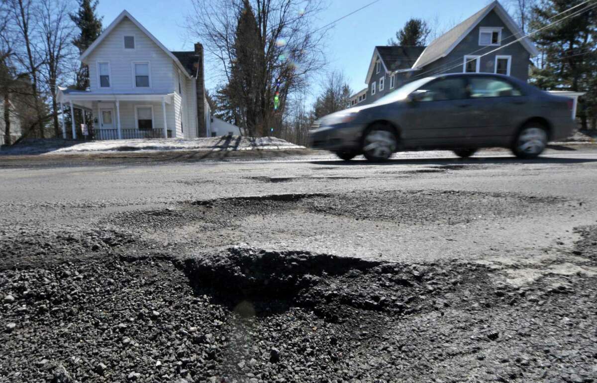 Potholes on Kenwood Avenue near Gardiner Terrace Tuesday March 18, 2014, in Bethlehem, NY. (John Carl D'Annibale / Times Union)