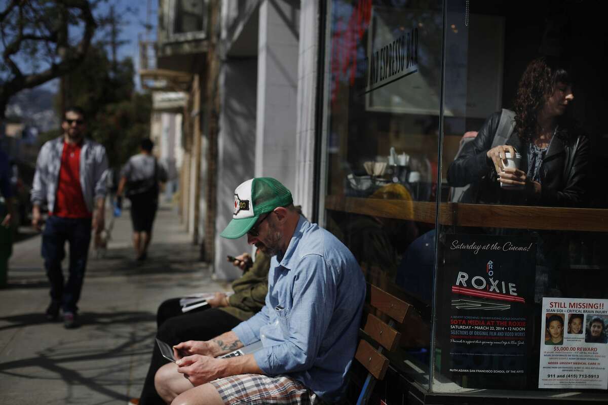 Pete Glikshtern of San Francisco works on his computer as he sits on a bench along 18th Street near Guerrero Street on Friday, March 21, 2014, in San Francisco, Calif.