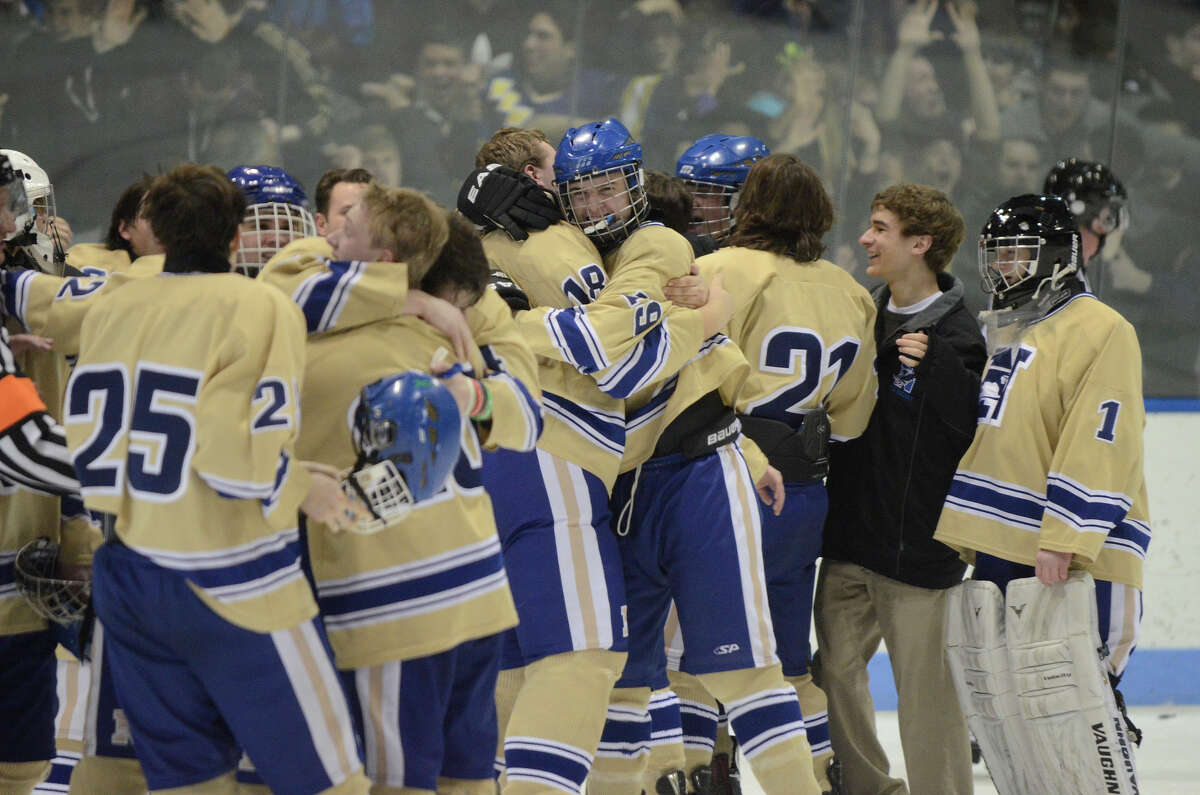 Newtown players celebrate at the end of the game as Newtown High School beats E.O. Smith-Tolland High School in Division III state finals at Ingalls Rink in New Haven, CT on Sat., March 22, 2014.