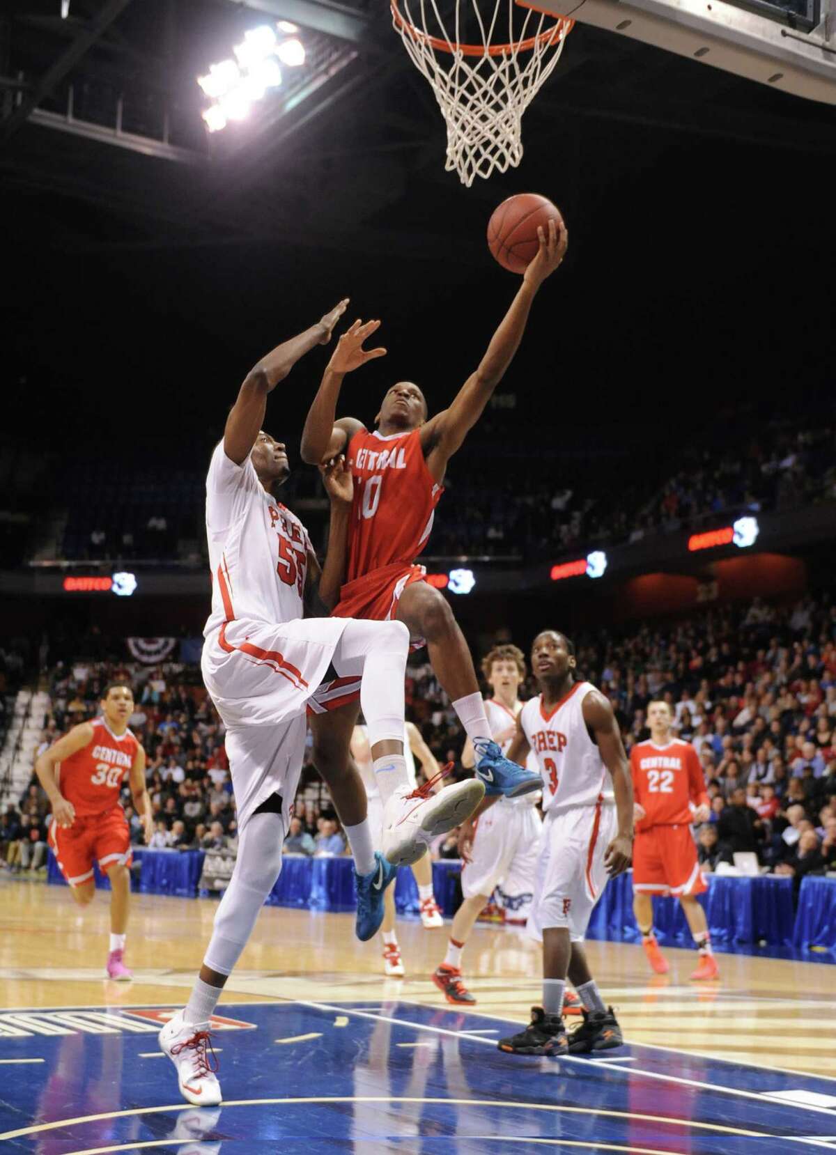 Bridgeport Central's Sha'quan Bretoux (10) attempts a layup over Fairfield Prep defender Paschal Chukwu (55) in the CIAC Class LL high school boys basketball state championship game between No. 1 Fairfield Prep. and No. 2 Bridgeport Central at Mohegan Sun Arena in Uncasville, Conn. on Saturday, March 22, 2014.