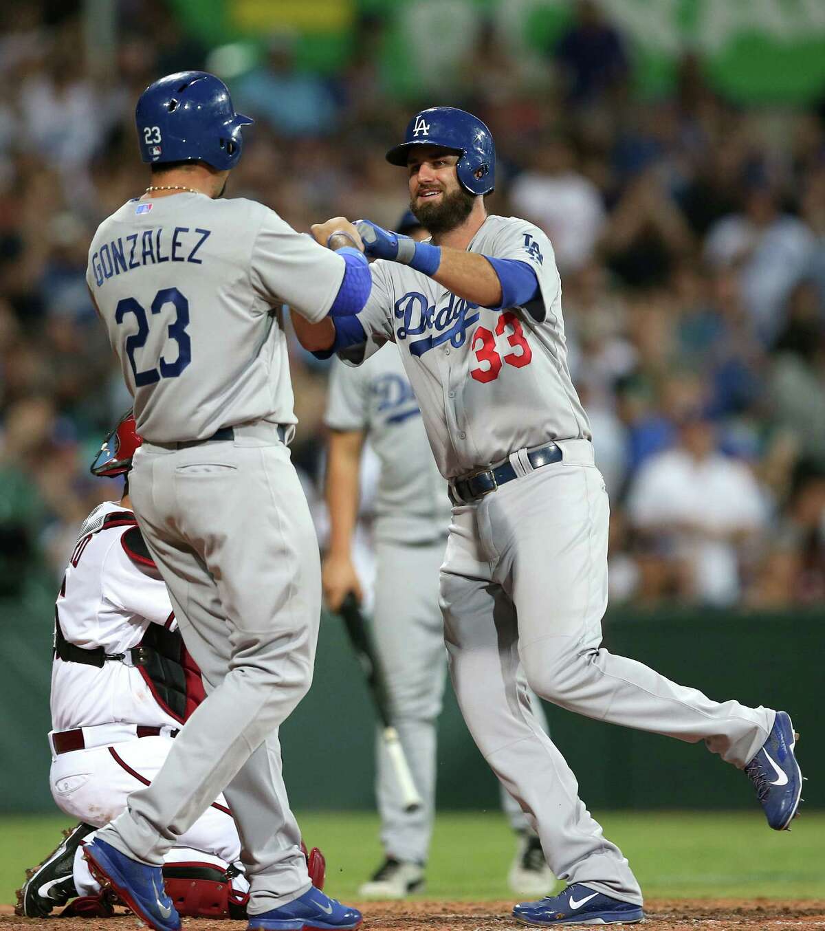 Adrian Gonzalez (left) congratulates Scott Van Slyke after Van Slyke hit a two-run home run in the Dodgers' 3-1 season-opening victory against the Diamondbacks in Sydney.