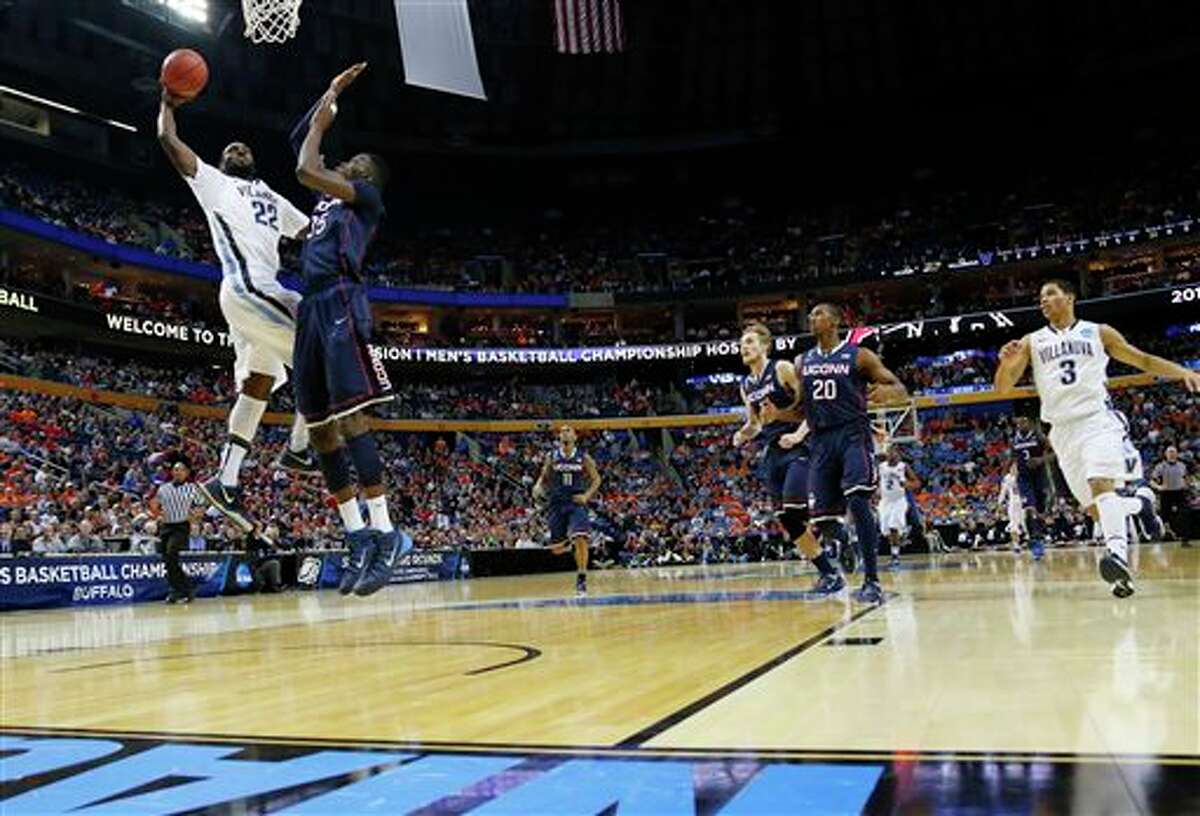 Villanova's JayVaughn Pinkston (22) shoots over Connecticut's Amida Brimah (35) during the first half of a third-round game in the NCAA men's college basketball tournament in Buffalo, N.Y., Saturday, March 22, 2014. (AP Photo/Bill Wippert)
