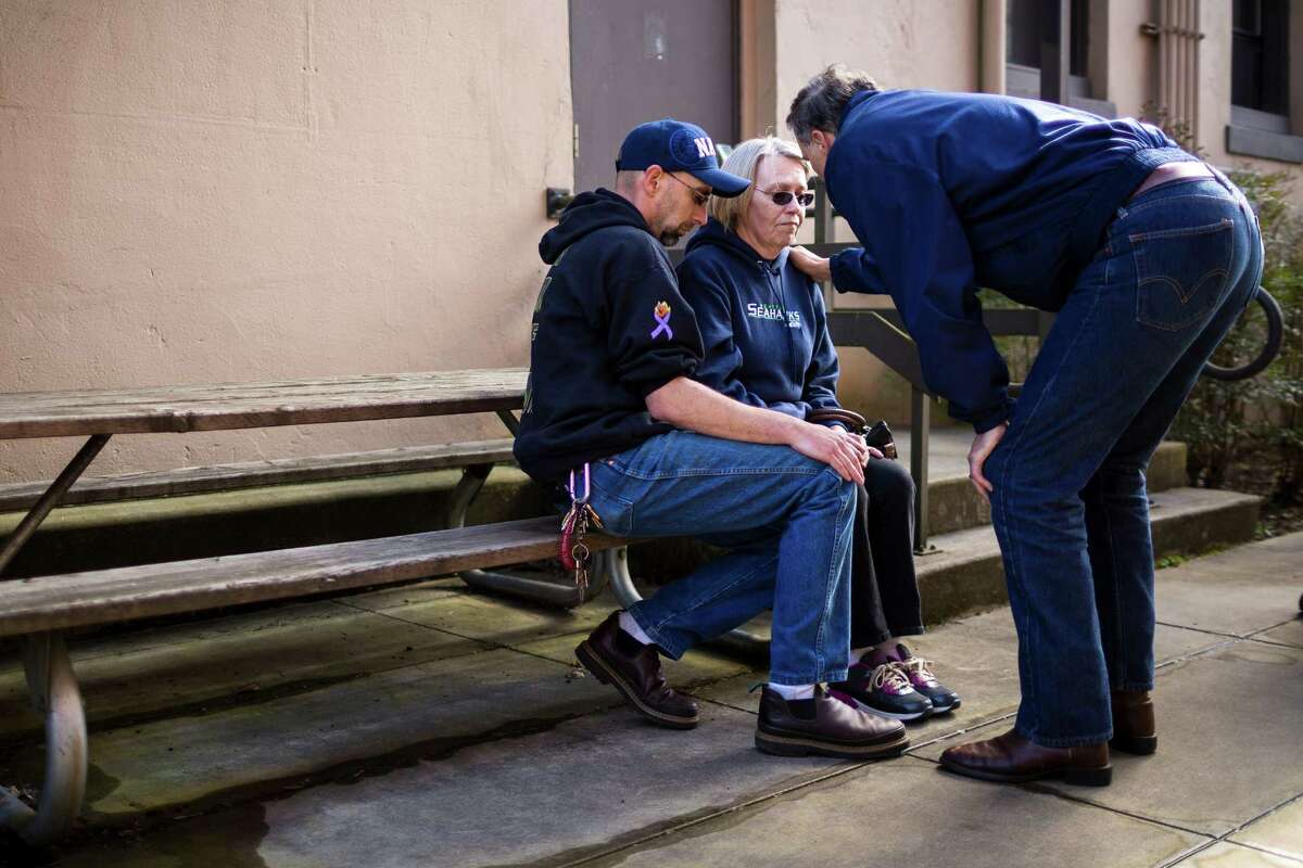 Barbara Welsh, center right, a mudslide victim whose husband is still missing, is comforted by Governor Jay Inslee, right, following a media availability segment Sunday, March 23, 2014, during a outside of the Arlington Police Department in Arlington, Wash. Authorities say 18 people are unaccounted for after a massive mudslide killed at least three people and destroyed 30 homes, forcing evacuations from fears of the Stillaguamash River flooding.