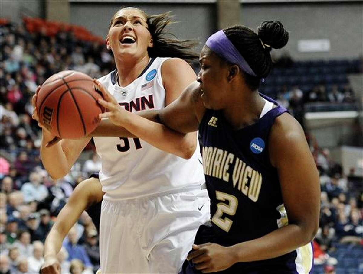 Prairie View A&M's Shamiya Brooks, right, fouls Connecticut's Stefanie Dolson, left, during the first half of a first-round game of the NCAA women's college basketball tournament, Sunday, March 23, 2014, in Storrs, Conn. (AP Photo/Jessica Hill)