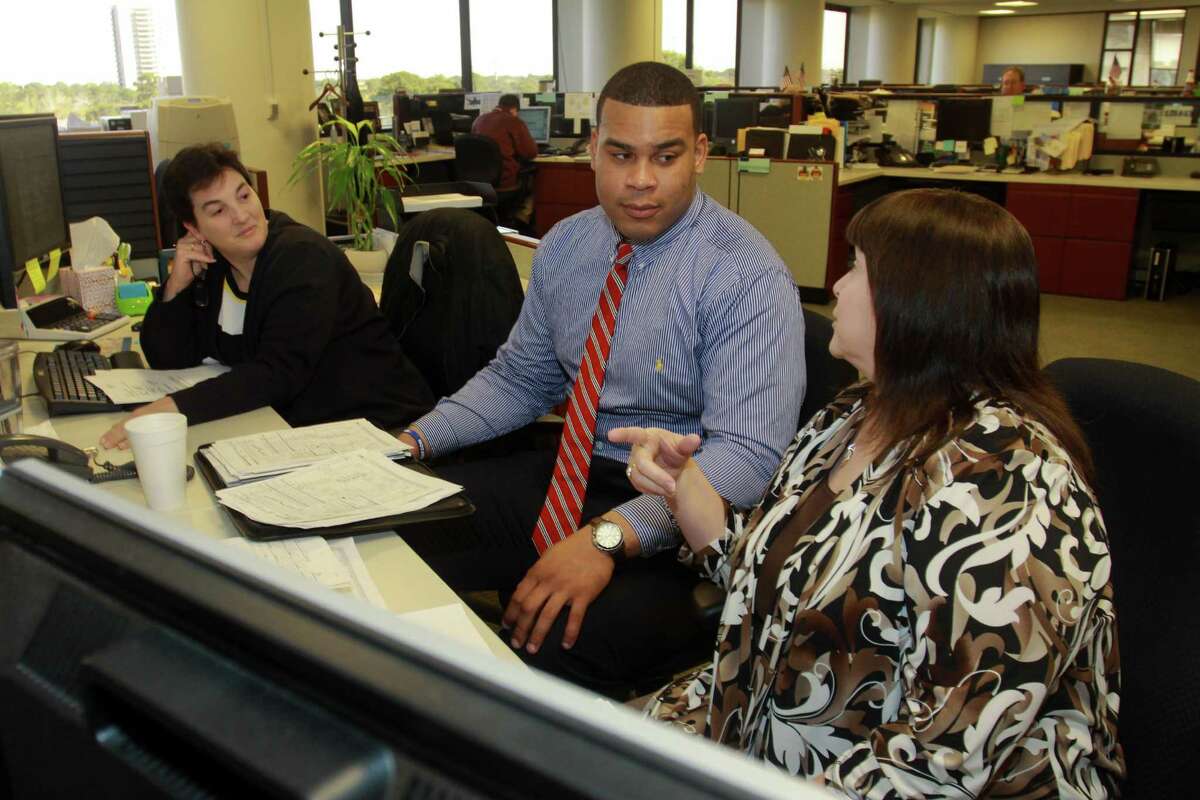 Then-Texans offensive lineman Brandon Brooks worked as an intern at Amegy Bank with Dawn Fontana, left, and Kathy Phillips during the 2014 offseason.