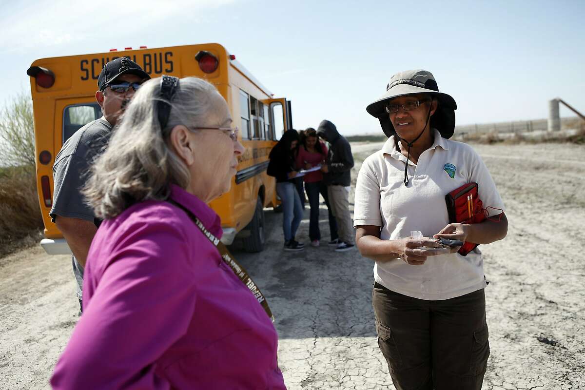 Atwell Island Sanctuary site manager Jihadda Govan, right, talks with substitute biology teacher Mrs. Atwell while her class visits native plant survivability plots in the Sanctuary in Alpaugh, CA, Thursday, March 20, 2014. Farmer Jack Mitchell has sold about 2000 acres of his ranch to the Atwell Island Sanctuary which, through the Bureau of Land Management, is turning former farm land in the San Joaquin Valley back to it's natural pre-agraculture state.