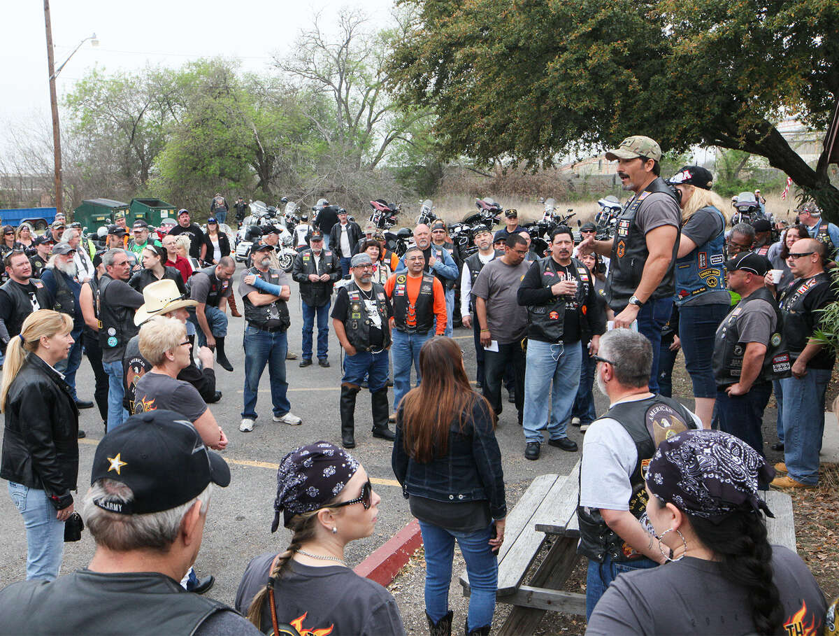 Riders get instruction from Road Captain Ron Pompa (standing on table on right) prior to the start of Saturday's 10th annual Rolling Run sponsored by Converse American Legion Post 593.