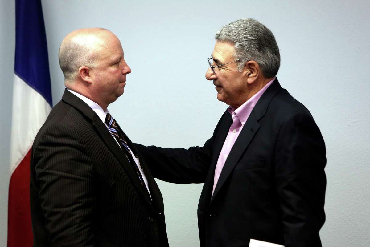 Bexar County Commissioner Kevin Wolff speaks with Alamo Area Council of Governments Executive Director Dean Danos after the AACOG executive committee voted to terminate Danos and Deputy Director Mike Quinn who have been on paid administrative leave since last month, when questions arose about their relationship with a tenant who never paid rent.