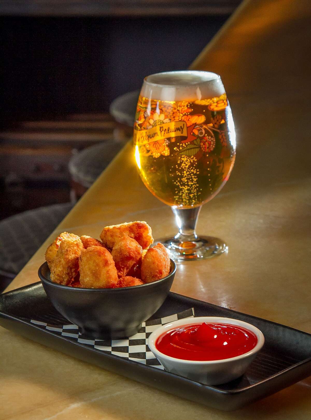 The Gourmet Tots with a Pilsner Urquell at Noir Lounge, Calif., is seen on Wednesday, March 19th, 2014.