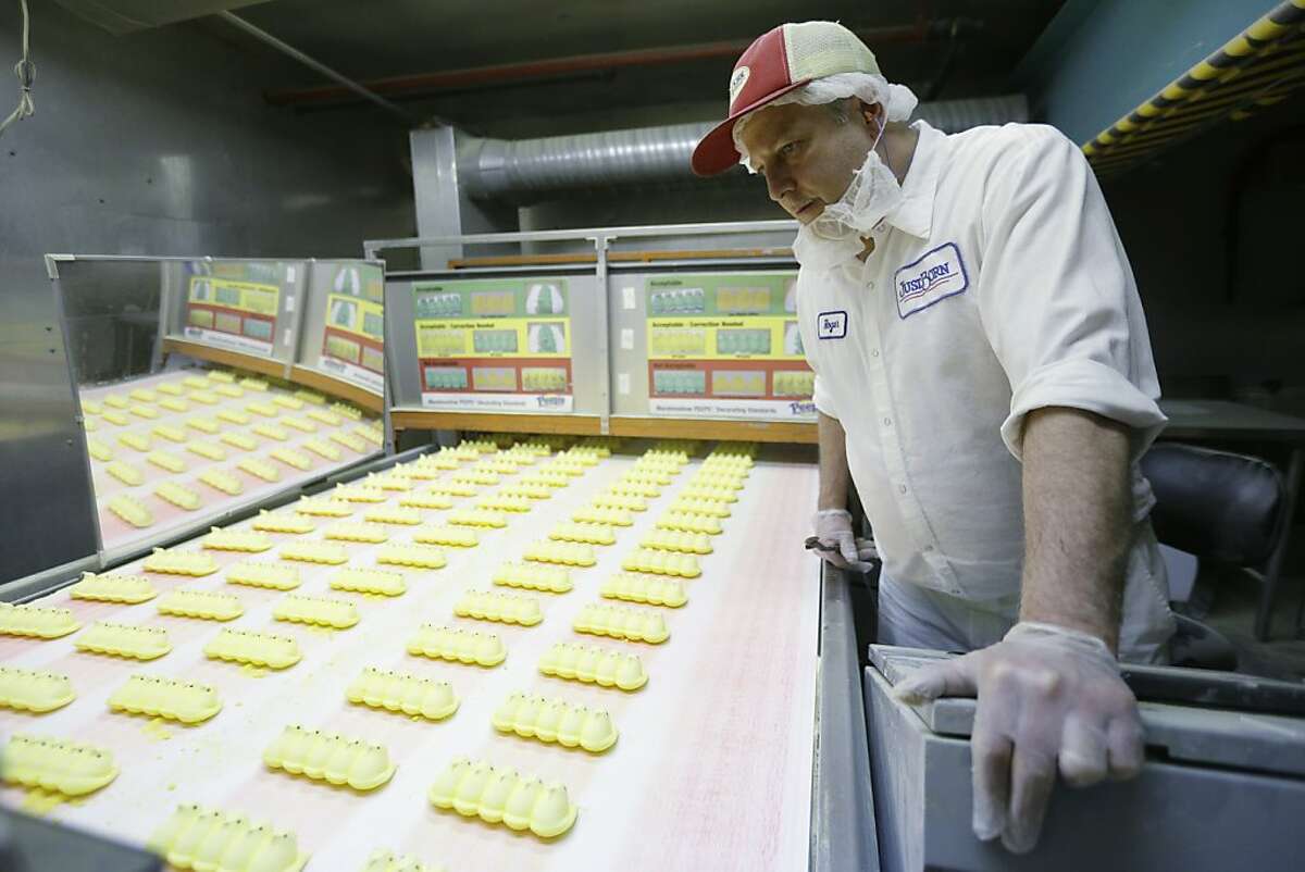 Roger Hildebeitel inspects Peeps as they move through the manufacturing process at the Just Born factory Wednesday, Feb. 13, 2013, in Bethlehem, Pa. (AP Photo/Matt Rourke)