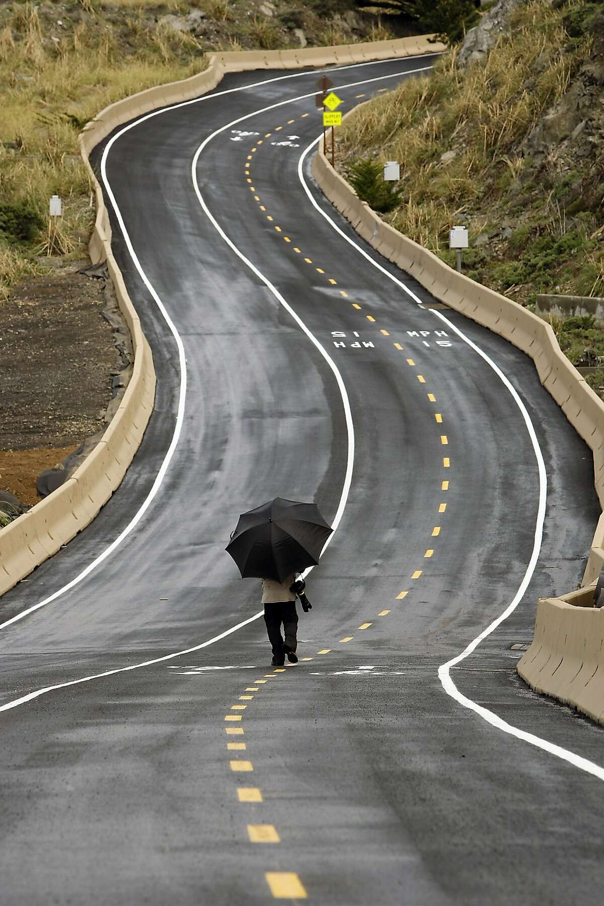 A member of the media walks up along the trail during a media tour of the newly completed Devil's Slide Costal Trail in Montara, CA, Tuesday Mar. 25, 2014.