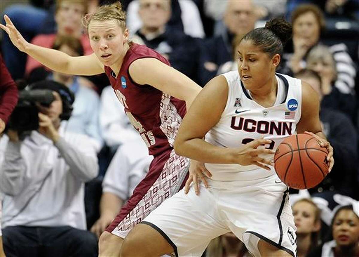 Connecticut's Kaleena Mosqueda-Lewis is guarded by Saint Joseph's Kelsey Berger, left, during the first half of a second-round game of the NCAA women's college basketball tournament, Tuesday, March 25, 2014, in Storrs, Conn. (AP Photo/Jessica Hill)