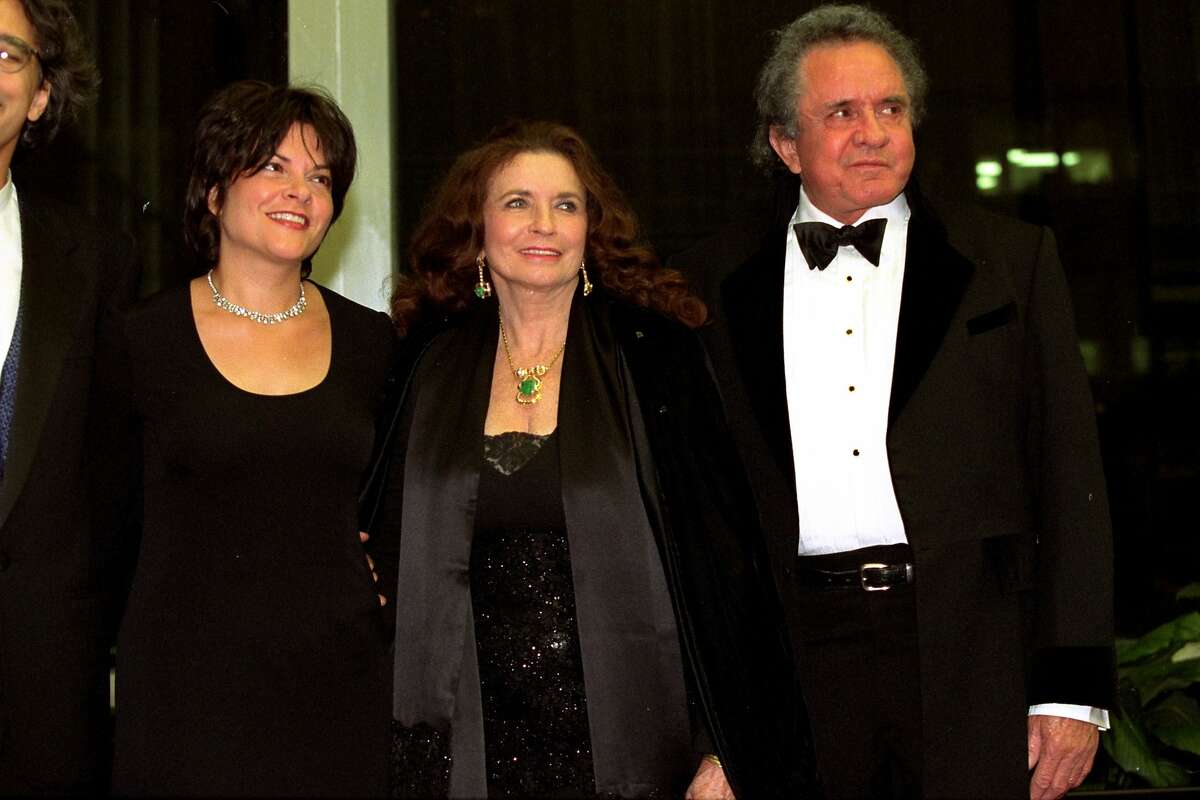 ** FILE ** Johnny Cash, right, a 1996 Kennedy Center Honors recipient, poses with his wife June Carter Cash and his daughter Roseanne Cash prior to the dinner celebrating the awards at the State Department in Washington, D.C., Dec. 7, 1996. June Carter Cash, a scion of a pioneering family in country music and the wife and Grammy-winning duet partner of singer Johnny Cash, died Thursday, May 15, 2003 of complications from heart surgery. She was 73. Cash died at Baptist Hospital in Nashville with her husband and family members at her bedside, manager Lou Robin said. (AP Photo/Tyler Mallory)
