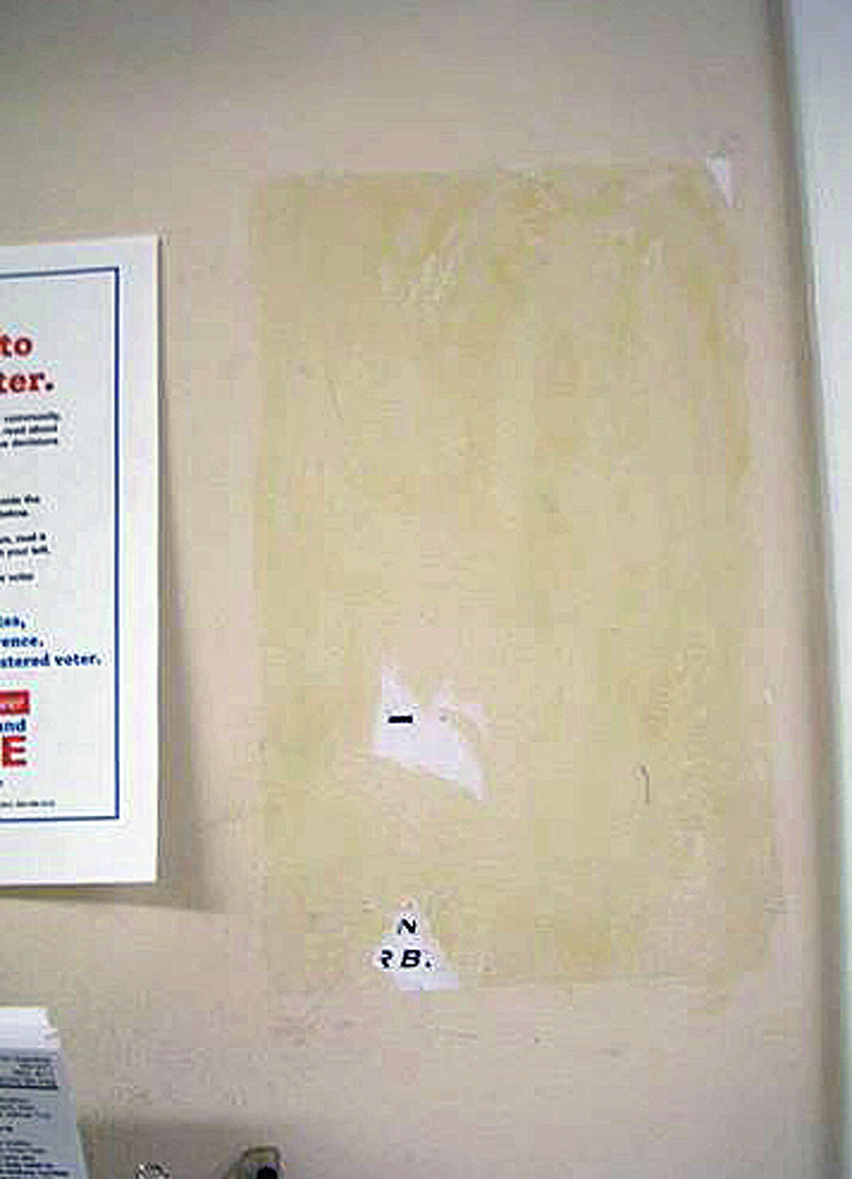 A blank spot on the wall outside the Registrar of Voters office in Old Town Hall. The missing sign indicated that the Republican registar's office was located on the second floor and had apparently been glued in place.