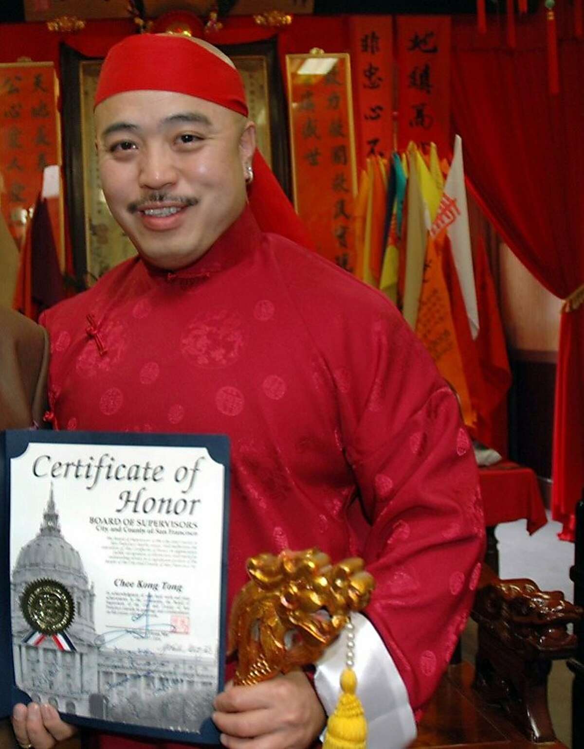 Raymond "Shrimpboy'' Chow, who was indicted on racketeering charges in 1992, shows the certificate that was arranged by city Supervisor Fiona Ma.