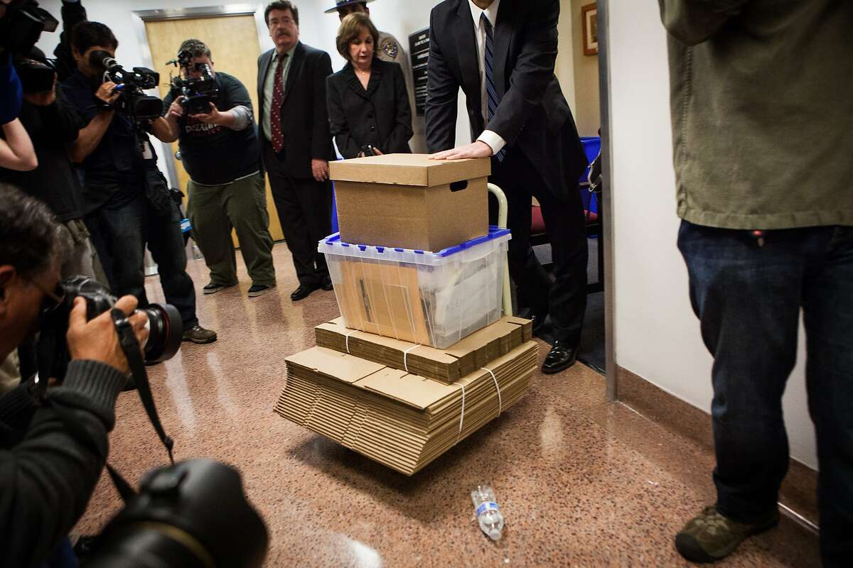 An FBI agent wheels boxes of evidence out of Senator Leland Yee's office at the State Capitol in Sacramento, California, March 26th.  The offices will remain open until June.