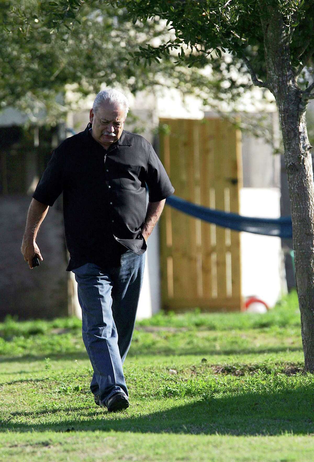 In this photo taken on Feb. 19, 2014, Hidalgo County Sheriff Lupe Trevino walks around a home that was raided north of Monte Cristo in Edinburg, Texas, as they searched for Jose Juan Mendoza after he kidnapped Juan Pedro Borjas. The Hidalgo County Sheriff office has announced Wednesday, March 26, 2014, that the Trevino's chief of staff has resigned for personal reasons, the latest high-level personnel change at an agency that has drawn the attention of federal investigators. (AP Photo/The Monitor, Gabe Hernandez) MAGS OUT; TV OUT