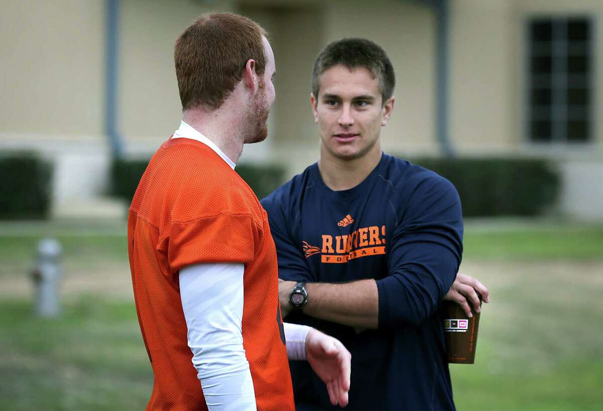 Eric Soza, right, UTSA quarterback from last year, talks to Tucker Carter, who will be a quarterback this year. Wednesday, March 26, 2014.