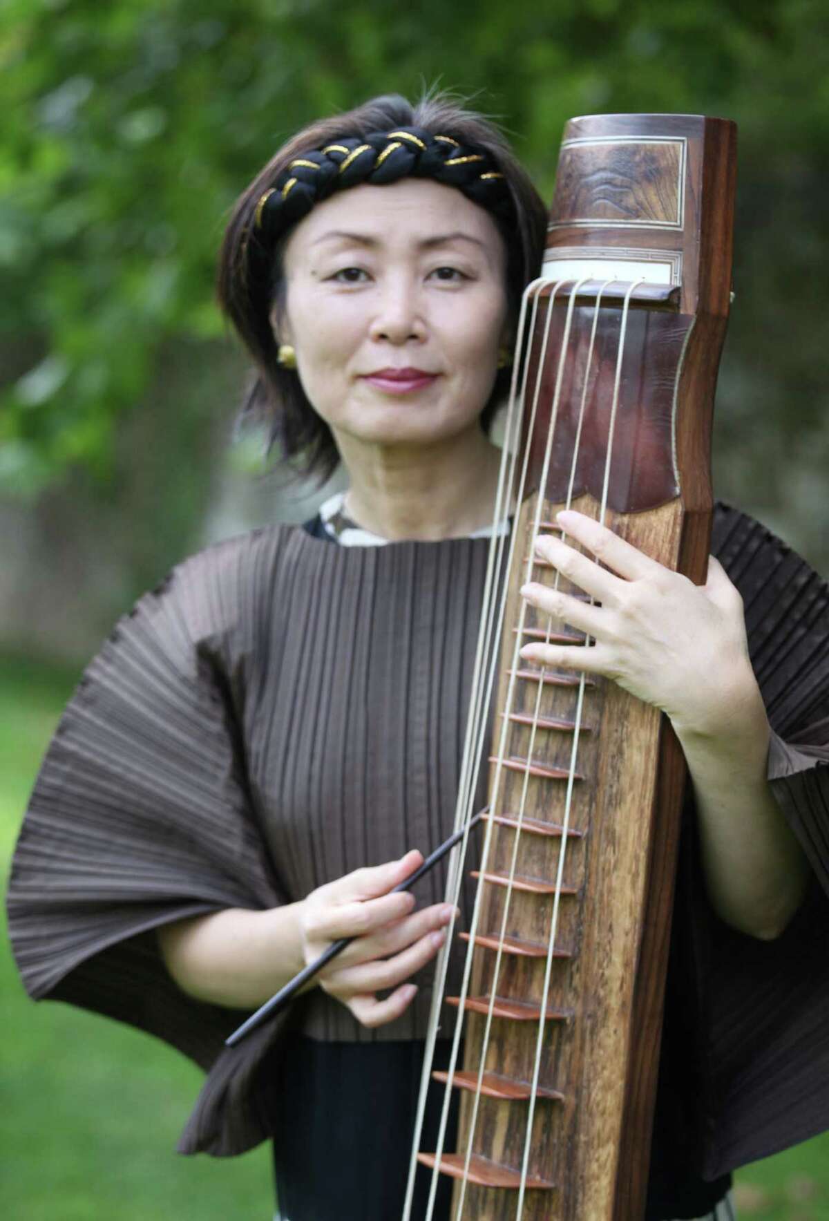 A world premiere of a choral work by composer Jin Hi Kim, pictured with her Korean komungo instrument, takes place Sunday, April 6, with the Mendelssohn Choir of Connecticut at Fairfield University. Her "Child of War" piece explores one of the most horrific, but iconic, photographs from the Vietnam War.