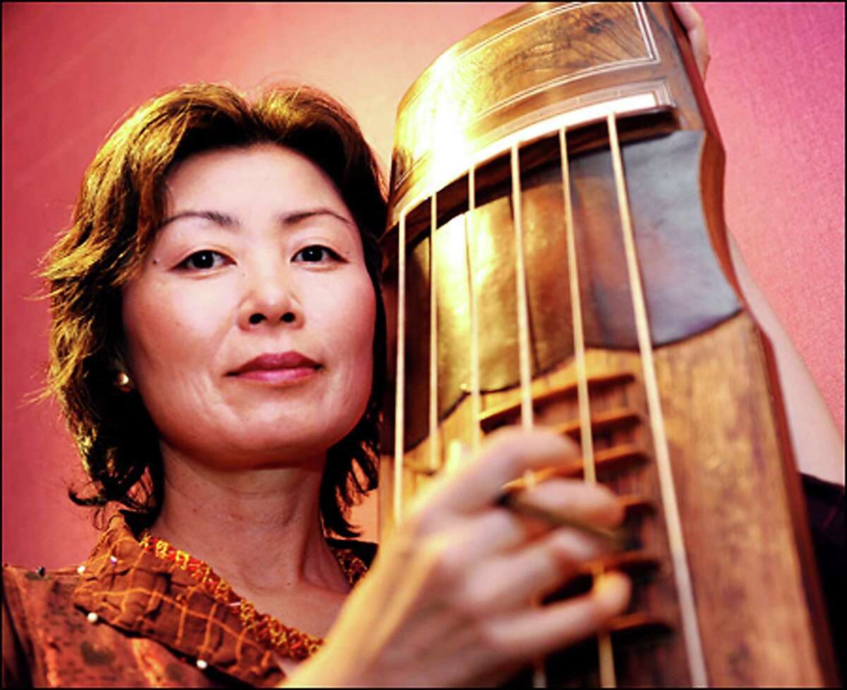 "Child of War," a piece by Korean composer Jin Hi Kim, above, will receive its debut with the Mendelssohn Choir of Connecticut on Sunday, April 6, at a "West Meets East" concert at Fairfield University. She also is renowned as a komungo performer and is shown with her instrument.
