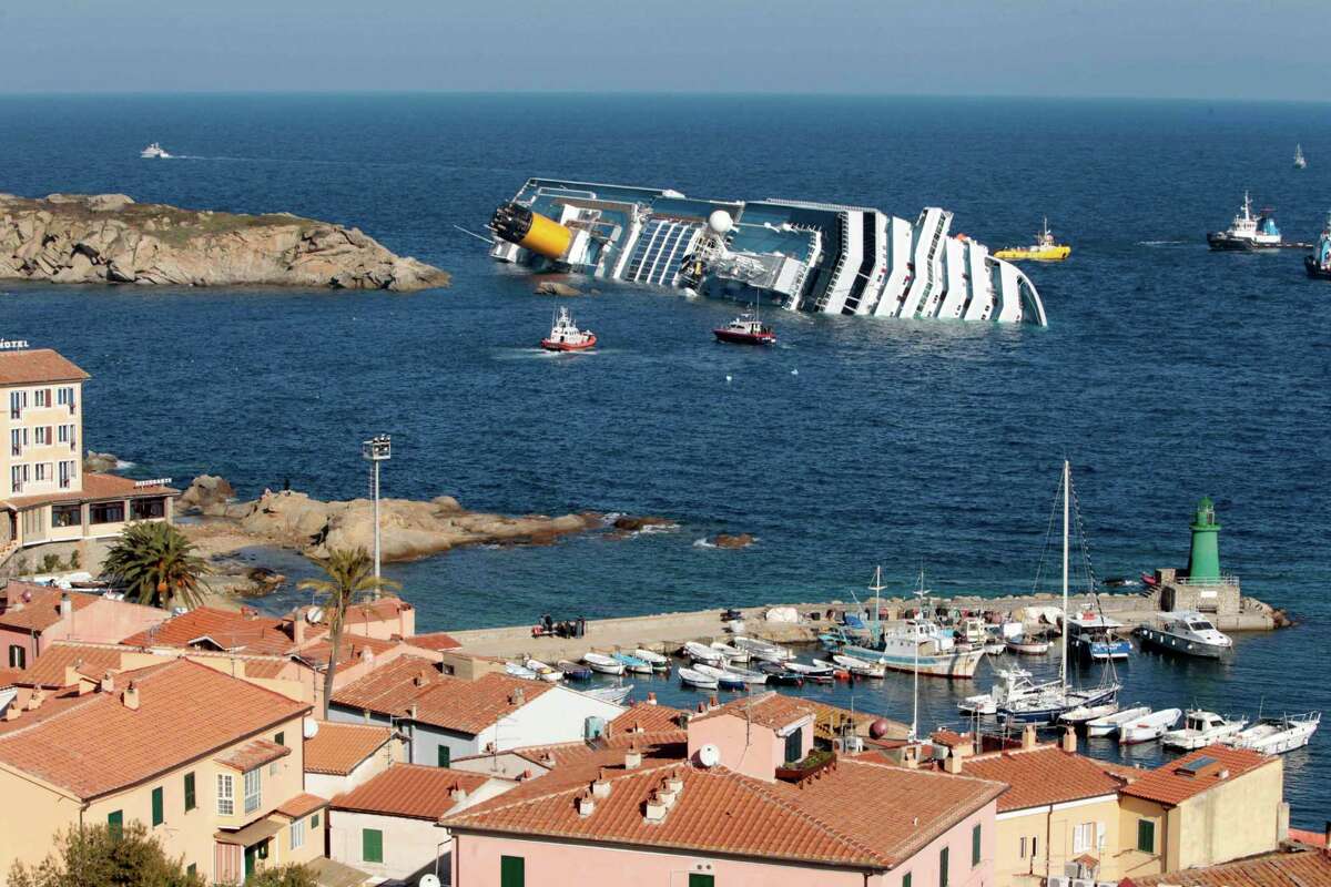 FILE - This Jan. 14, 2012 file photo shows the luxury cruise ship Costa Concordia leaning on its starboard side after running aground on the tiny Tuscan island of Giglio, Italy. Cruise operators, like airline pilots, may be relying too heavily on electronics to navigate massive ships, losing the knowledge and ability needed to operate a vessel in the case of a power failure, an expert sea pilot told a federal agency on Wednesday, March 26, 2014 (AP Photo/Gregorio Borgia, File)