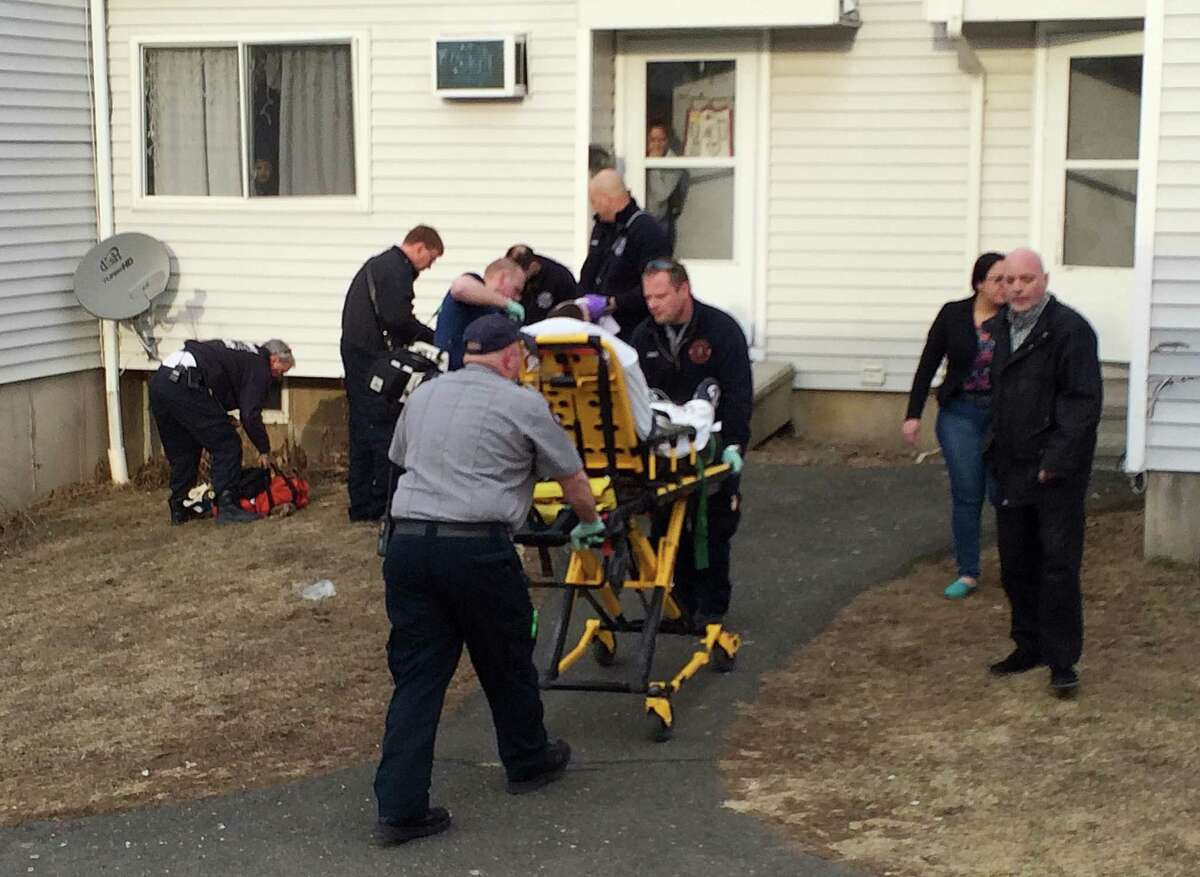 EMTs carry the victim of a shooting on a stretcher at the Beaver Street housing complex in Danbury, Conn. on Thursday, March 27, 2014.