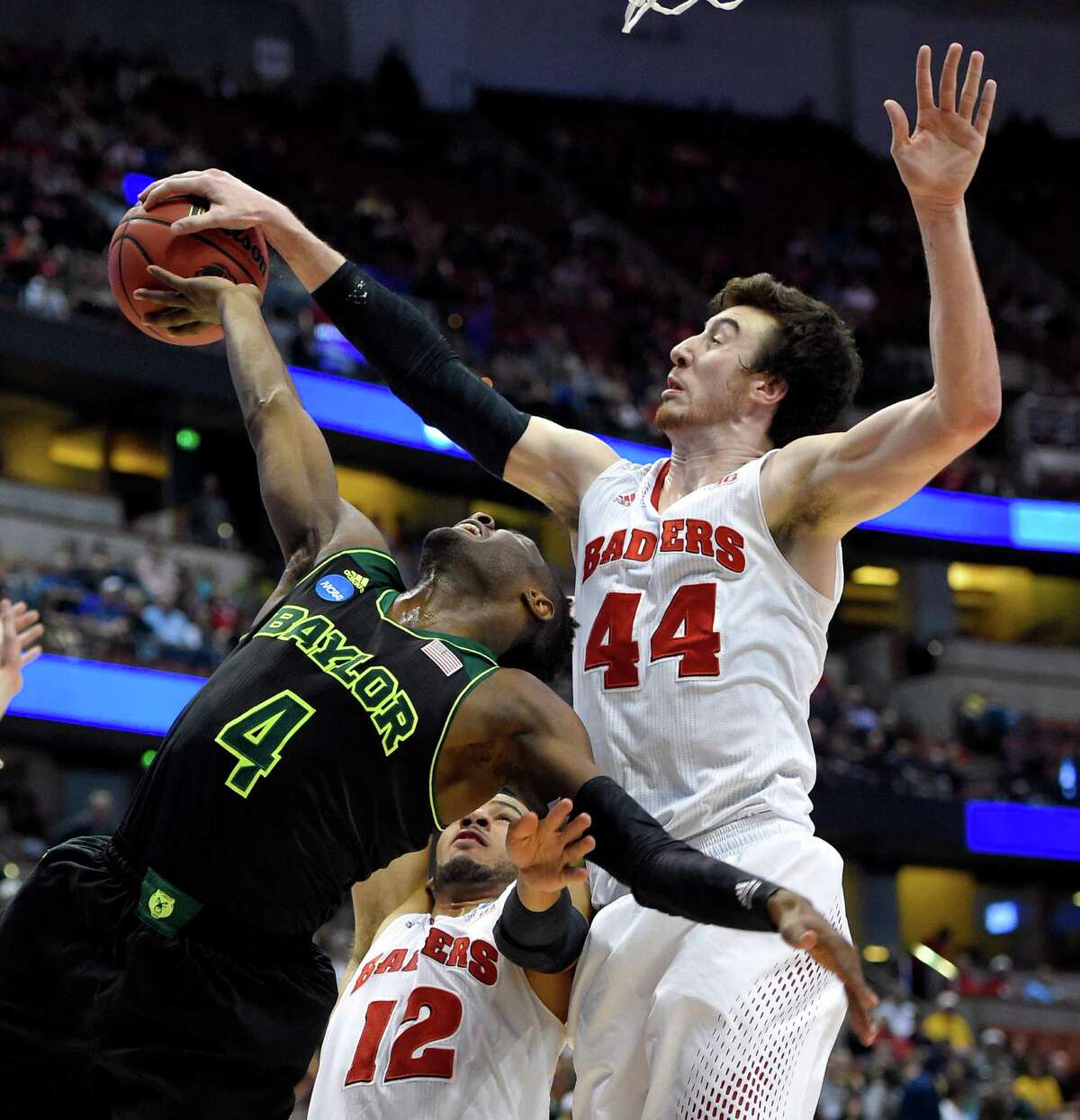 Baylor guard Gary Franklin (4) has a shot stopped by Wisconsin forward Frank Kaminsky (44) during an NCAA men's college basketball tournament regional semifinal, Thursday, March 27, 2014, in Anaheim, Calif. (AP Photo/Mark J. Terrill) ORG XMIT: CACC212