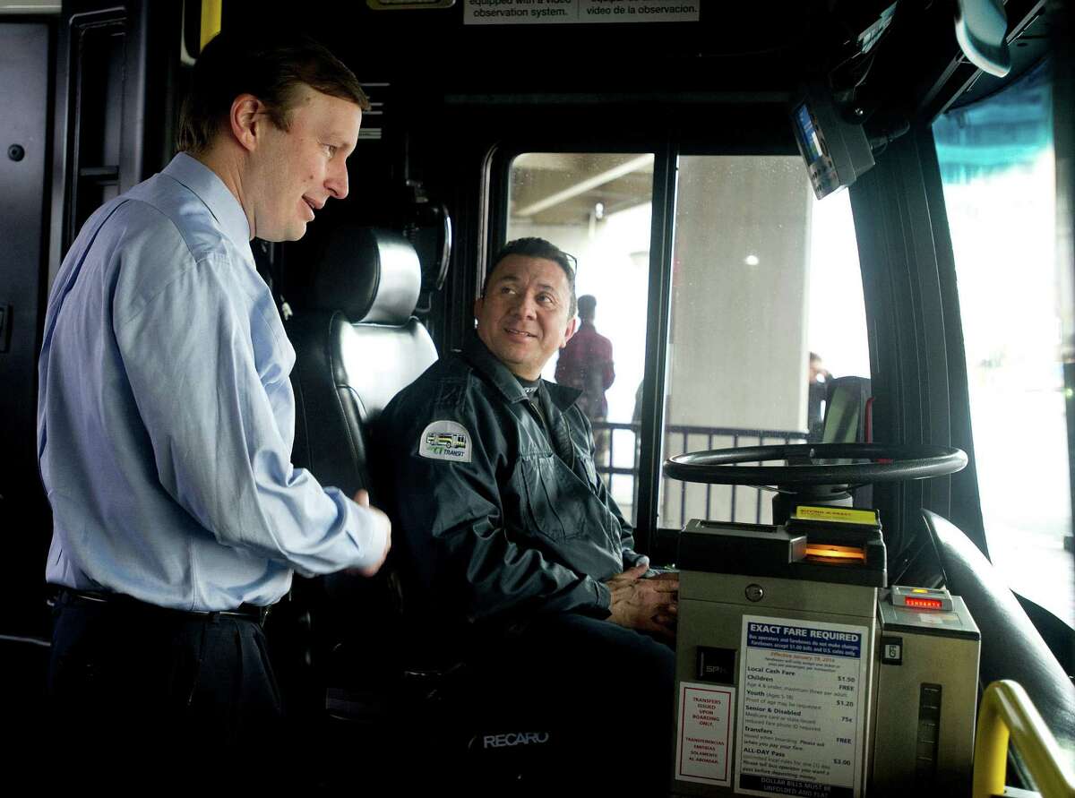 Sen. Chris Murphy speaks with bus driver Hector Jacinto before he rode the Stamford bus from the transit center up the Hope Street line on Friday, March 28, 2014.