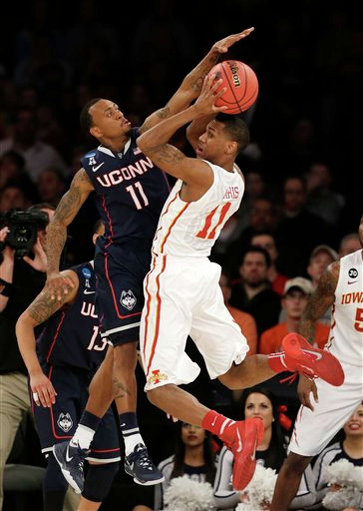 Connecticut's Ryan Boatright, left, reaches to block a pass by Iowa State's Monte Morris during the first half in a regional semifinal of the NCAA men's college basketball tournament Friday, March 28, 2014, in New York. (AP Photo/Seth Wenig)