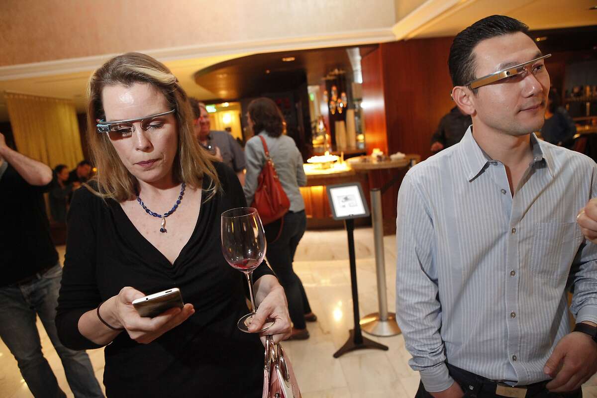 Liza Gere, left and Sean Im mingle during a Google Glass meet-up at the Stanford Court Hotel in San Francisco, CA, Friday March 28, 2014.