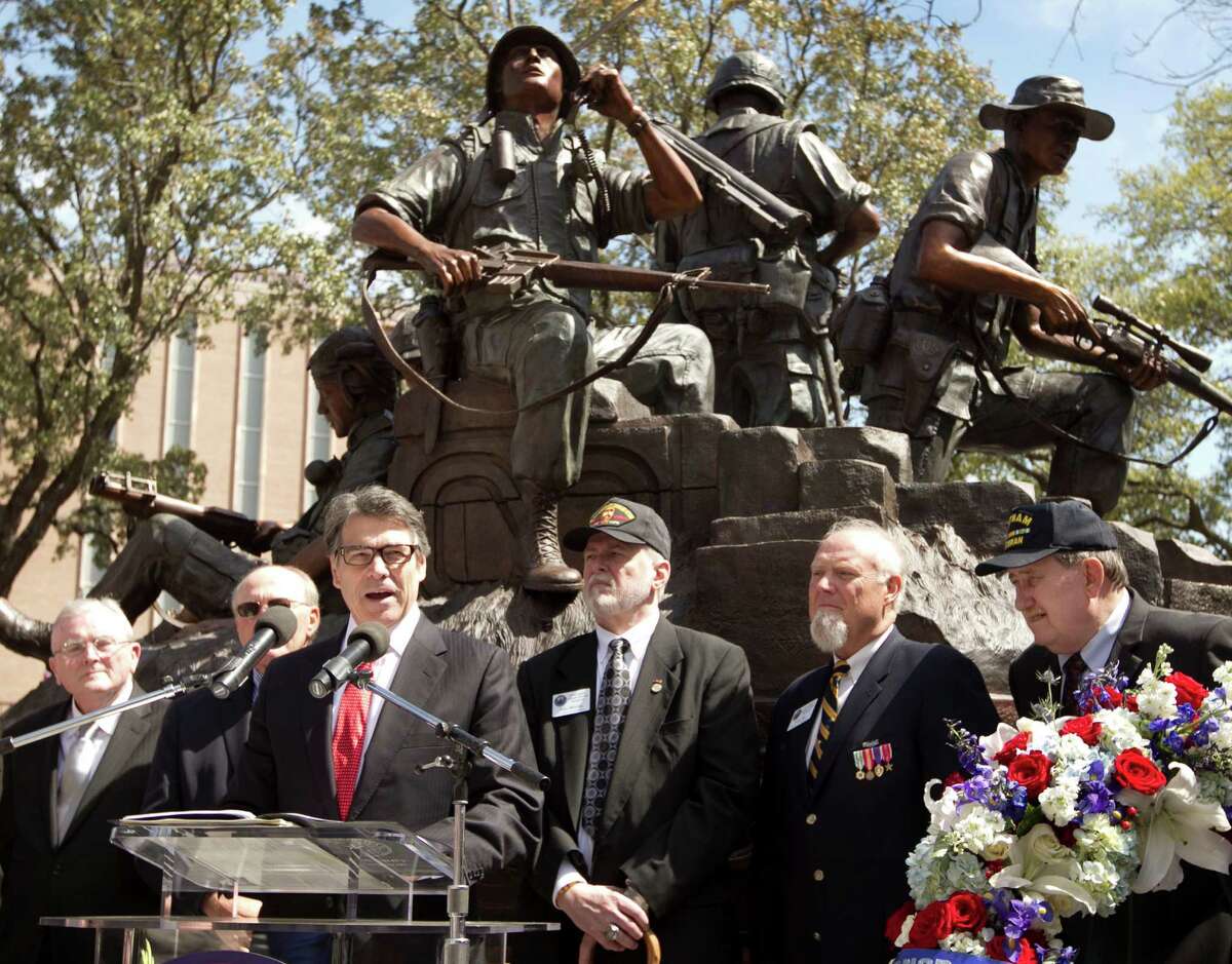 Texas Gov. Rick Perry speaks at the dedication of the Texas state Capitol Vietnam Veterans Monument in Austin, Texas, Saturday March 29, 2014. The dedication Saturday morning marks the 41st anniversary of the last U.S. troops leaving South Vietnam. About a half-million Texans served in the war, with more than 3,400 losing their lives and 105 still missing in action. (AP Photo/Austin American-Statesman, Jay Janner)