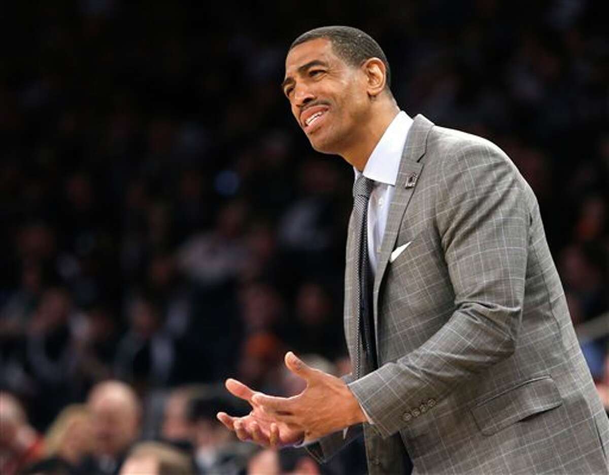Connecticut head coach Kevin Ollie instructs his team in the first half of a regional final against Michigan State at the NCAA college basketball tournament on Sunday, March 30, 2014, in New York. (AP Photo/Frank Franklin II)