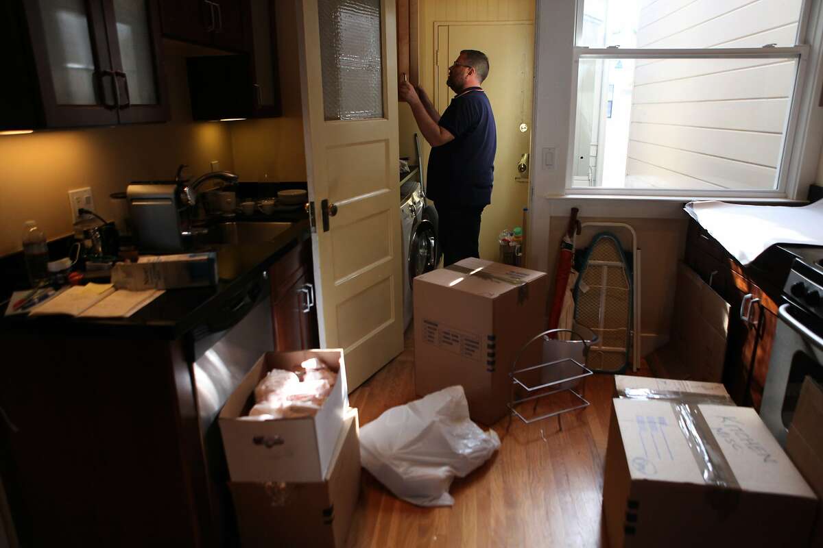 Dan Kennedy packs some of his last stuff as he moves out of his old unit and into a place he just bought, in San Francisco, Calif. on March 30, 2014.
