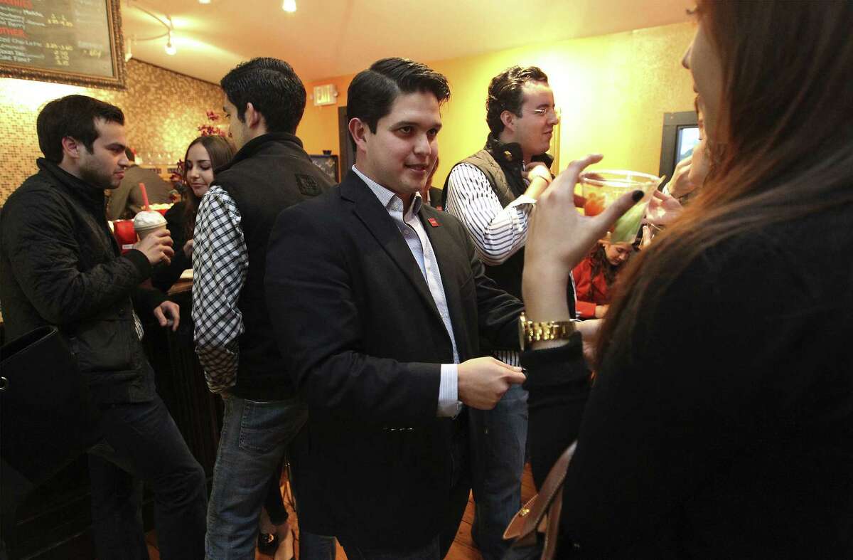 Juan Pablo Alcantar (center) talks with guests at a student mixer for the Association of Mexican Entrepreneurs at Copalli Café. The organization's objective is to help young Mexican entrepreneurs succeed in the United States.