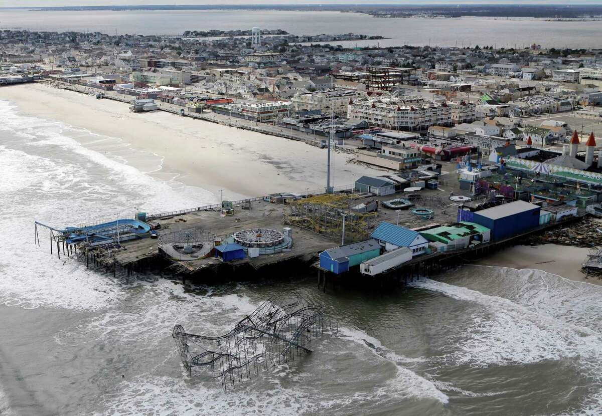 FILE - This Oct. 31, 2012 file photo, shows an aerial view of the damage to an amusement park left in the wake of Superstorm Sandy, in Seaside Heights, N.J. Freaky storms like 2013âs Typhoon Haiyan, 2012âs Superstorm Sandy and 2008âs ultra-deadly Cyclone Nargis may not have been caused by warming, but their fatal storm surges were augmented by climate changeâs ever rising seas, Maarten van Aalst, a top official at the International Federation of Red Cross and Red Crescent Societies said. Global warming is driving humanity toward a whole new level of many risks, a United Nations scientific panel reports, warning that the wild climate ride has only just begun. (AP Photo/Mike Groll, File)