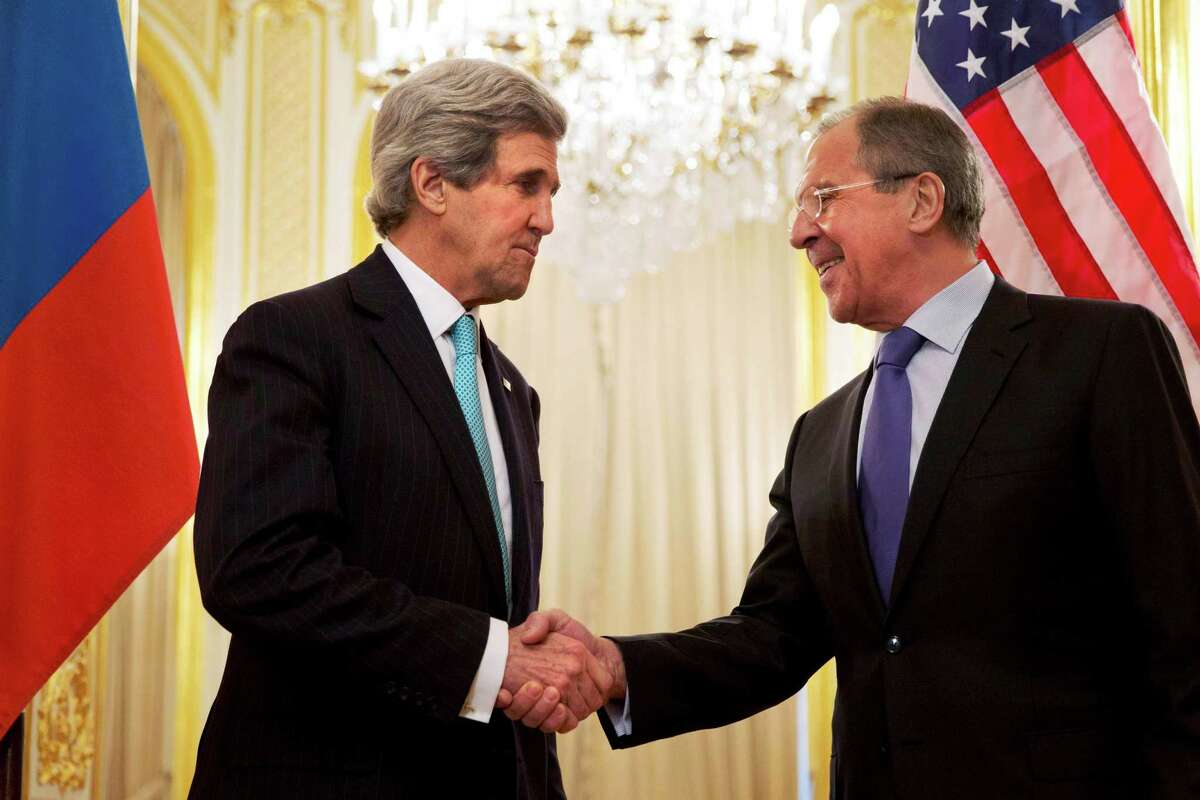 U.S. Secretary of State John Kerry (L) shakes hands with Russian Foreign Minister Sergei Lavrov before their meeting at the Russian Ambassador's residence in Paris March 30, 2014. REUTERS/Jacquelyn Martin/Pool (FRANCE - Tags: POLITICS)