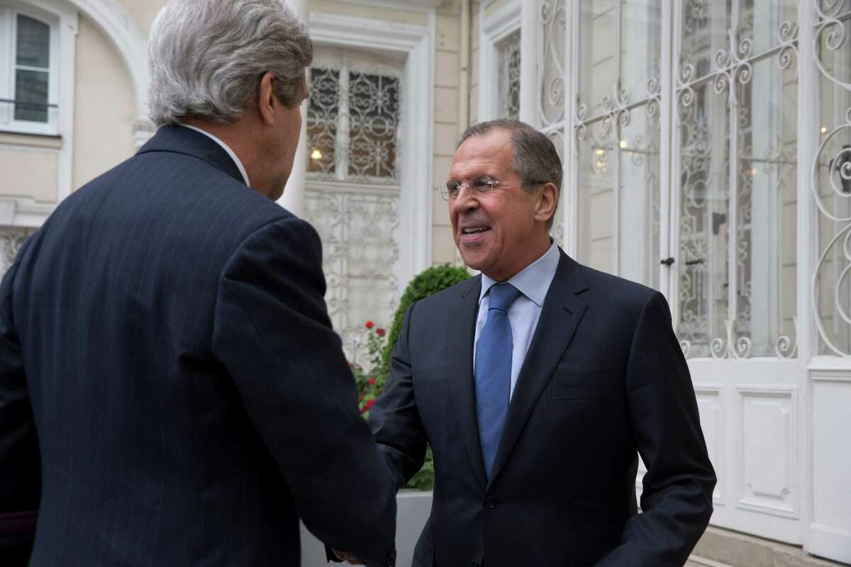 U.S. Secretary of State John Kerry, left, is greeted by Russian Foreign Minister Sergey Lavrov at the Russian Ambassador's residence for a meeting to discuss Ukraine, in Paris, Sunday March 30, 2014. Kerry traveled to Paris for the last minute meeting with Lavrov. (AP Photo/Jacquelyn Martin, Pool)