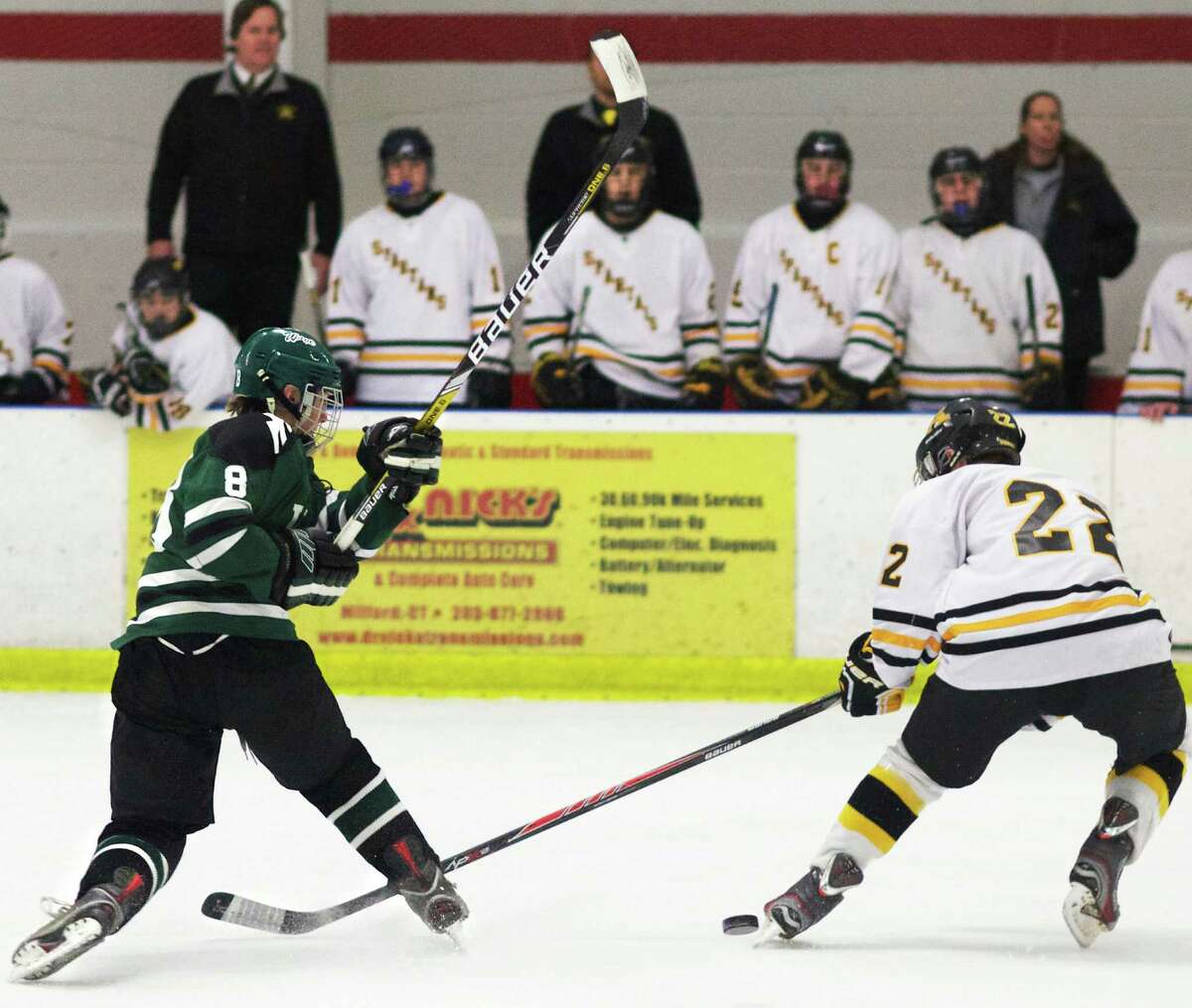 Blaine McMahon of the Green Wave fires a shot during New Milford High School ice hockey's Division II state tournament quarterfinal match vs. Amity Regional, March 2014