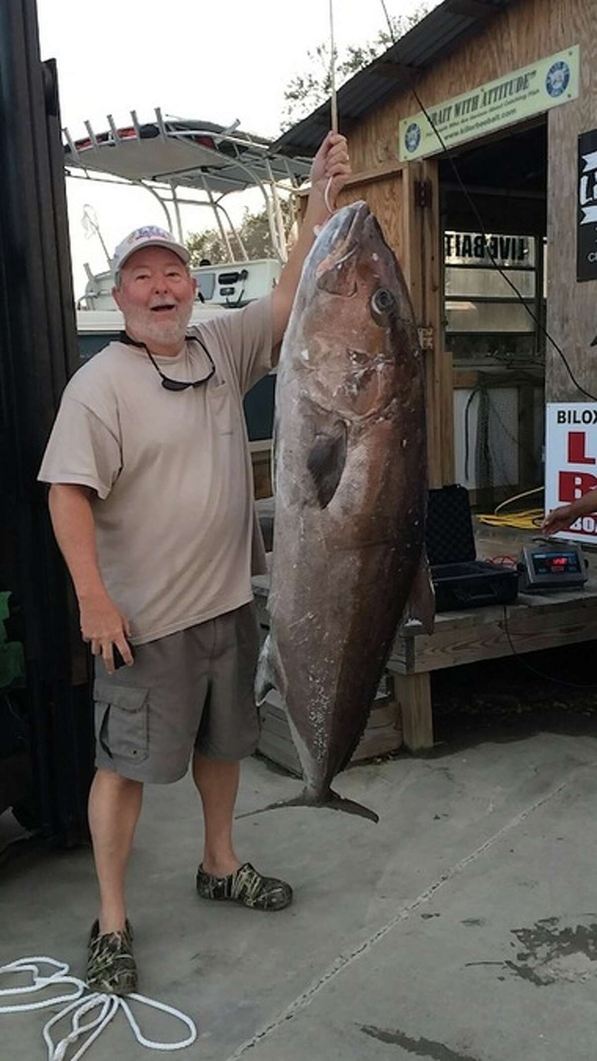 Don Wheeler of Laurel, Miss. holds up his record breaking catch, a 125lb 8oz Greater Amberjack.
