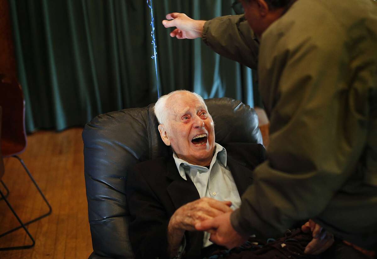 Marc Platt greets a friend at his 100th birthday celebration in Mill Valley, Calif., on Sunday, December 8, 2013.