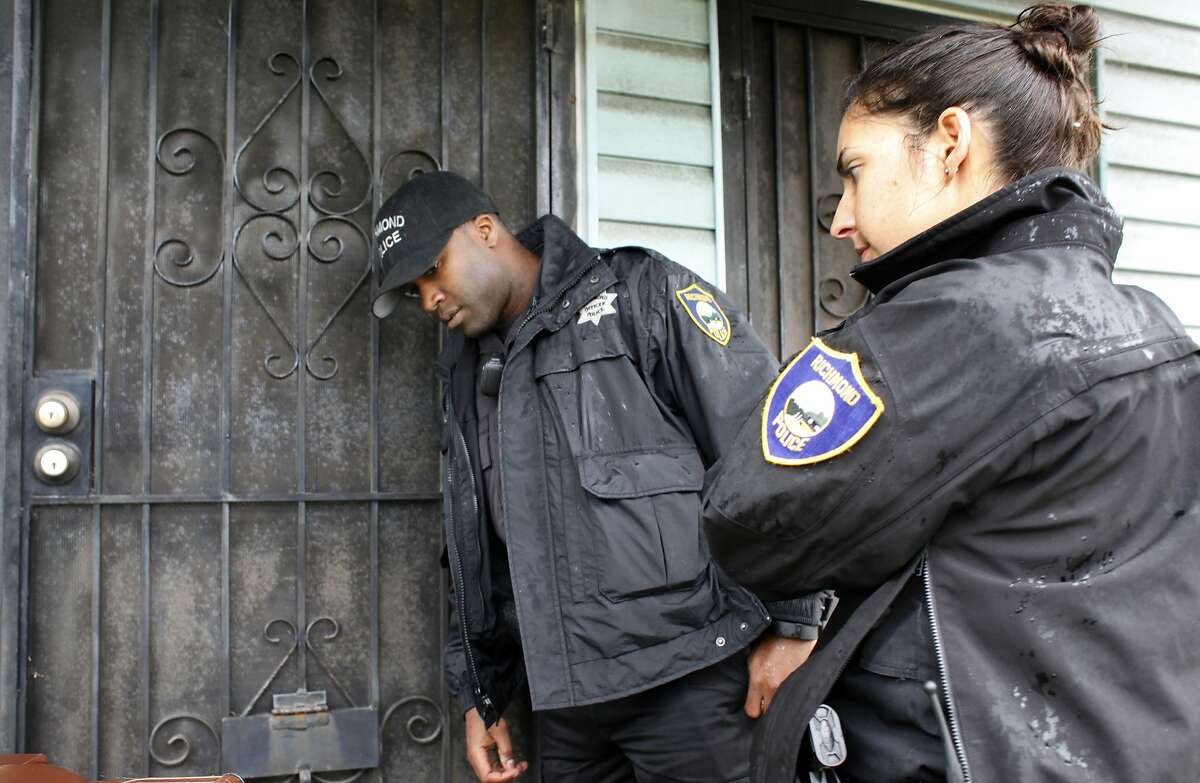 Richmond Police Officers Brandon Ruffin and Jennifer Cortez of the Bravo Unit check on the well being of a stroke victim that didn't answer the phone, Monday March 20, 2014, in Richmond, Calif.