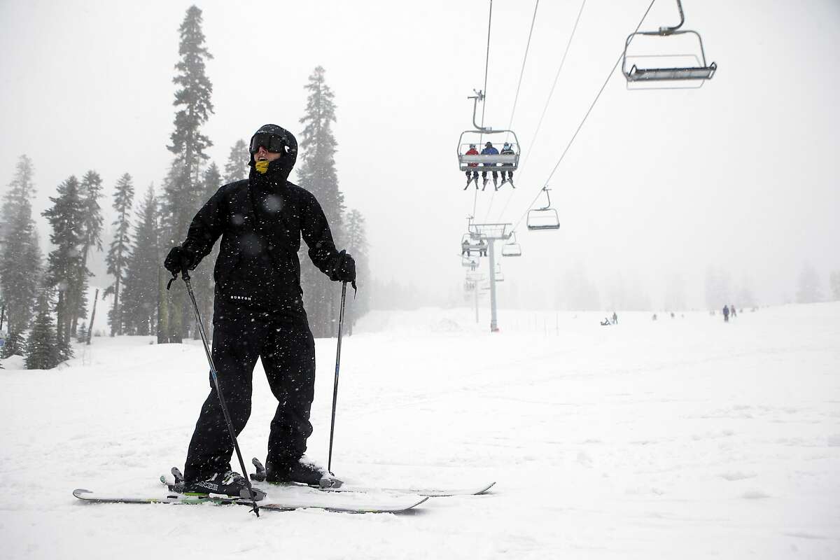 Kirk Anderson of Ripon, CA stands under a ski lift as he waits for friends at the bottom of a run at Sierra at Tahoe ski resort in South Lake Tahoe, CA, Saturday March 29, 2014.