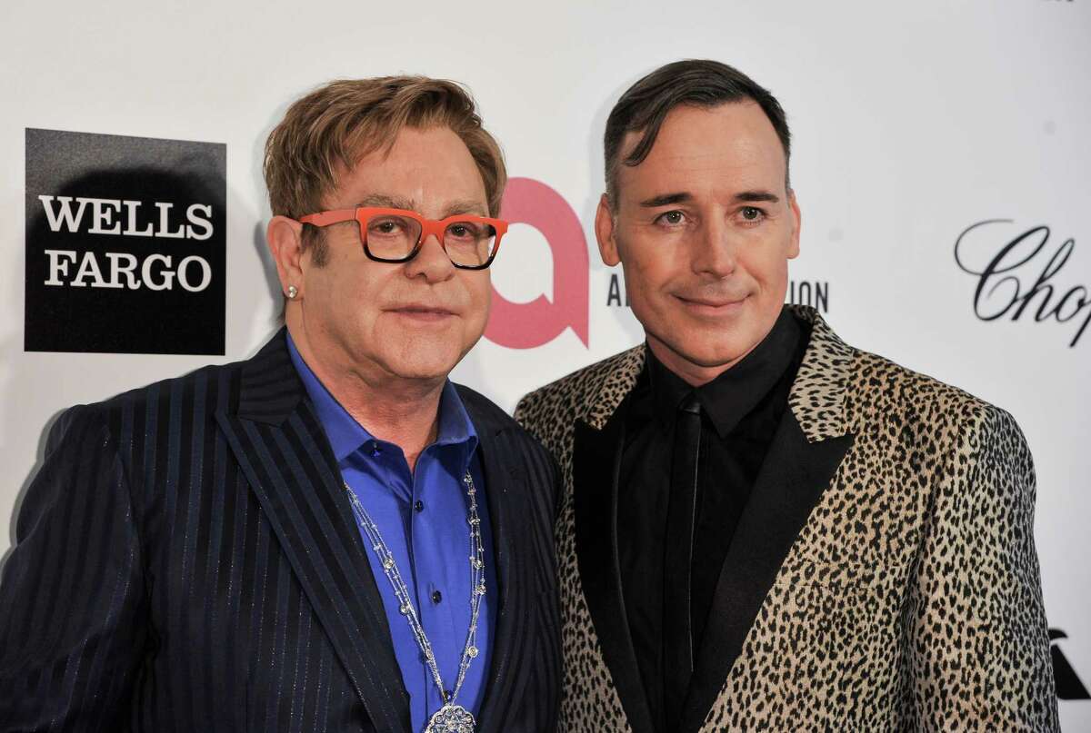 Elton John, left, and David Furnish arrive at the 2014 Elton John Oscar Viewing and After Party on Sunday, March 2, 2014, in West Hollywood, Calif. (Photo by Richard Shotwell/Invision/AP)
