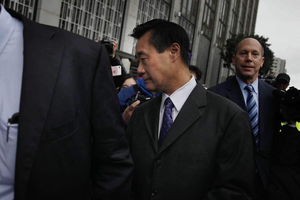 California state Sen. Leland Yee (center) leaves the Phillip Burton Federal Building and United States Courthouse with his attorney Paul DeMeester (partially seen at left) after a bond hearing on Monday, March 31, 2014, in San Francisco, Calif.