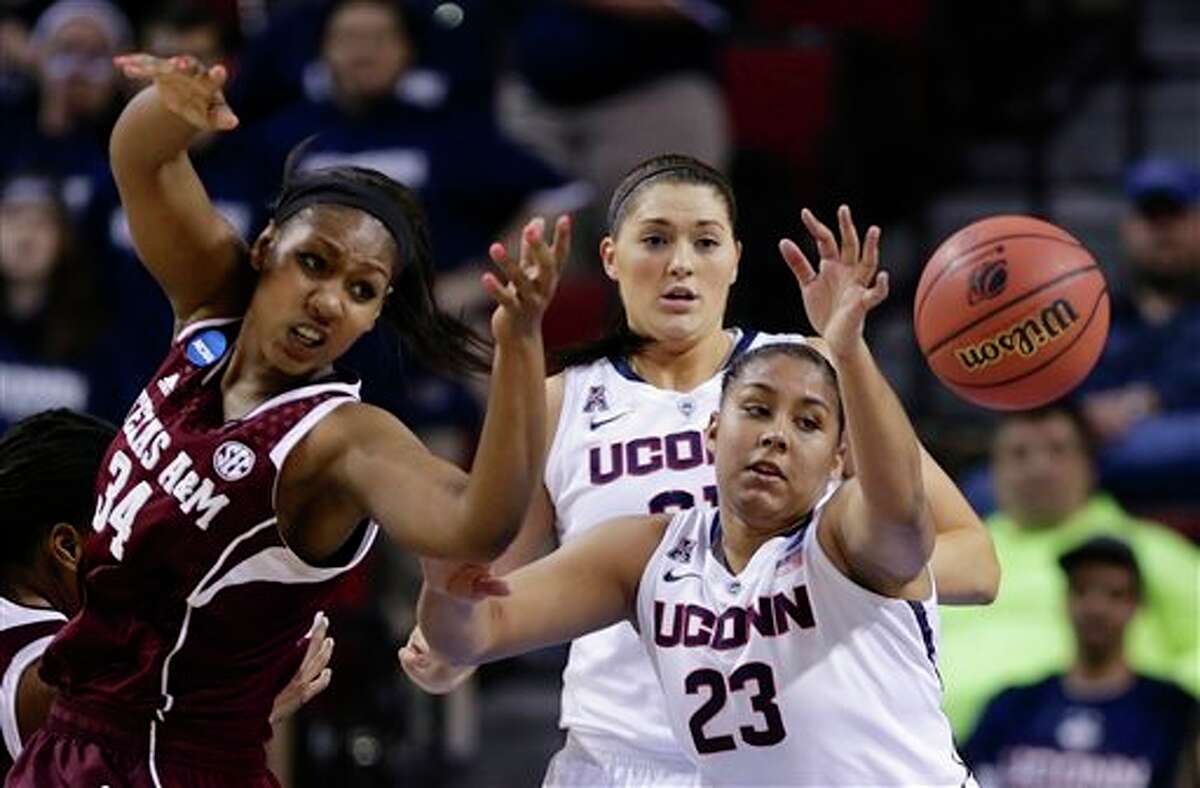Texas A&M's Karla Gilbert (34), Connecticut's Kaleena Mosqueda-Lewis (23) and Connecticut's Stefanie Dolson, center rear, go for a rebound during the first half of a regional final game in the NCAA college basketball tournament in Lincoln, Neb., Monday, March 31, 2014. (AP Photo/Nati Harnik)