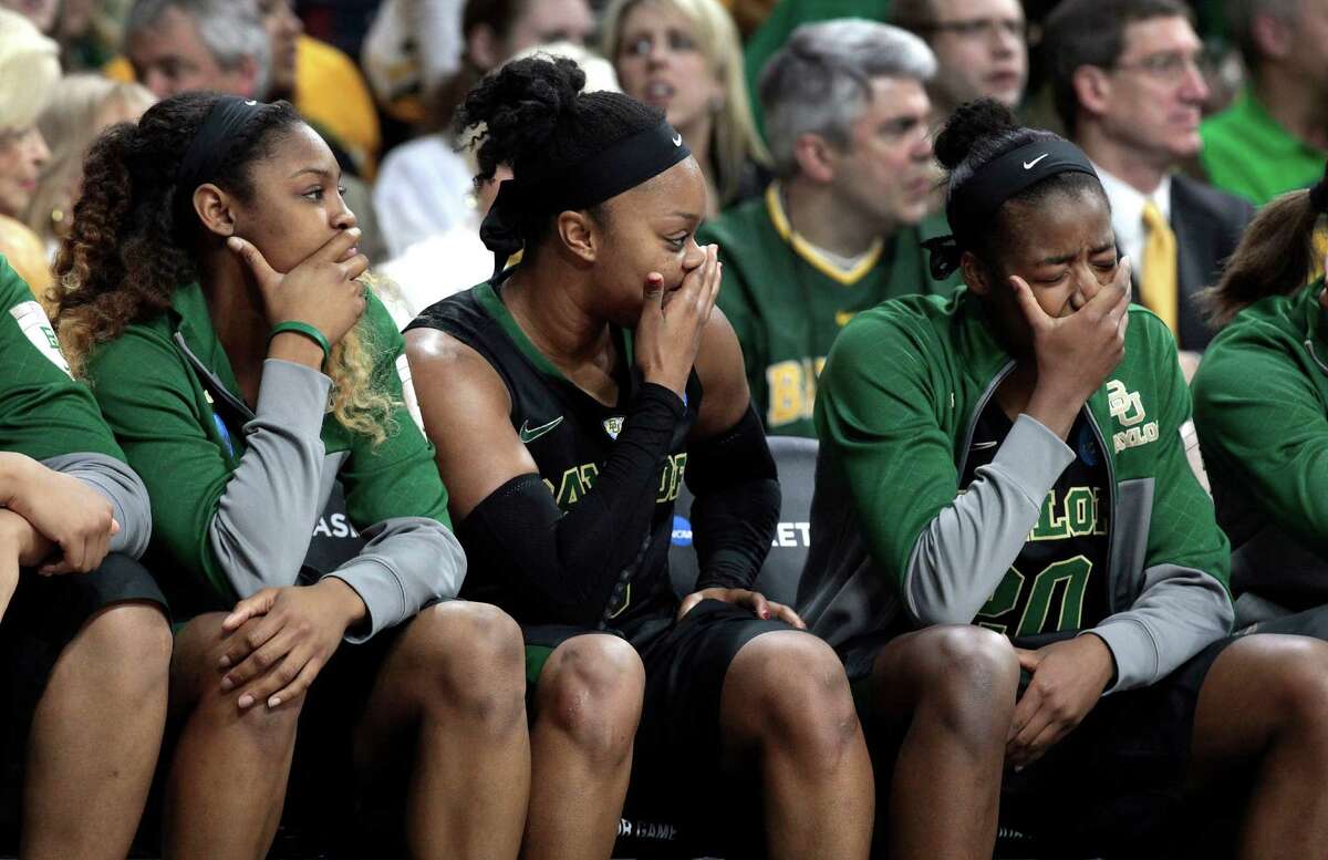 Baylor's Chardonae Fuqua', from left, Odyssey Sims and Imani Wright sit on the bench in the second half of their NCAA women's college basketball tournament regional final game at the Purcell Pavilion in South Bend, Ind., Monday, March 31, 2014. Notre Dame beat Baylor 88-69. (AP Photo/Paul Sancya)