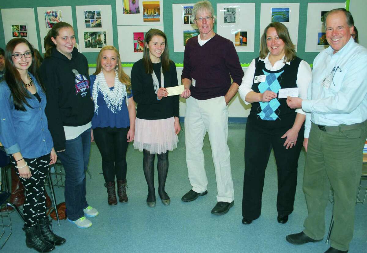 The New Milford River Trail Alliance recently received a donation from the New Milford High School Interact Club and the Rotary Club of New Milford toward the purchase of a bike rack to be placed in town. Above, from left to right, Interact Club treasurer Nicole Callisen, secretary Ashley Loser, vice president Tiana Lungo and president Emily Day present the clubâÄôs portion of the donation to Tom OâÄôBrien, the alliance chairman, as Lisa Arasim, treasurer of the alliance, receives a portion of the donation from Dr. Peter Daubner, the Rotary ClubâÄôs advisor to the Interact Club. Courtesy of New Milford High School